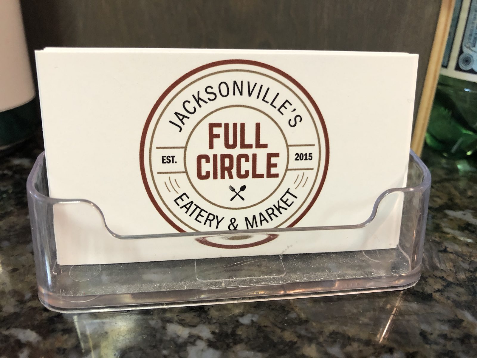 full circle business card featuring their logo that reads Jacksonville's Full Circle Eatery & Market, Established 2015